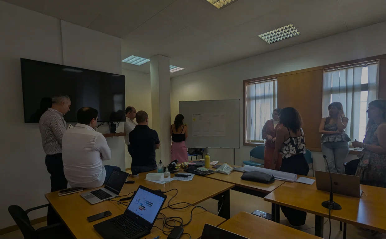 Group of people looking at a board during a workshop.